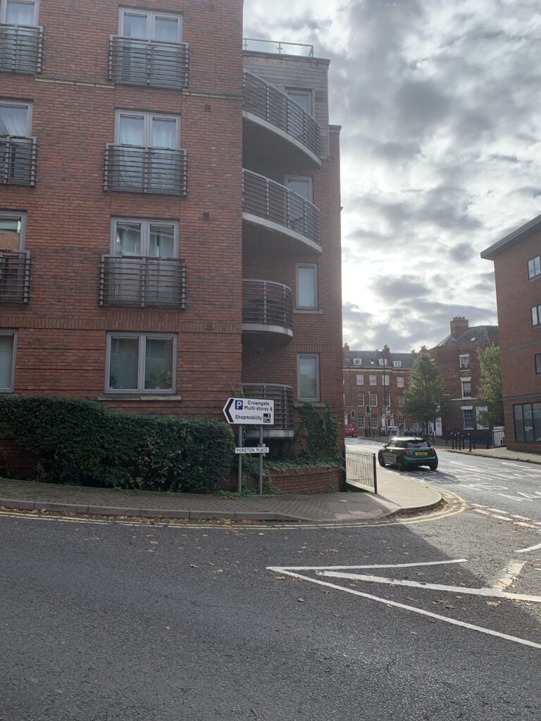 Left turn into Crowngate Multi-storey Car Park from Moreton Place, signposted for ShopMobility Worcester.