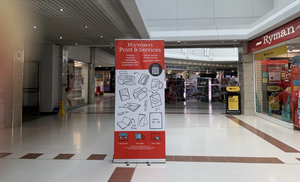 Interior of Friary Walk showing the Ryman shop, opposite the passageway leading to the lift for ShopMobility Worcester.