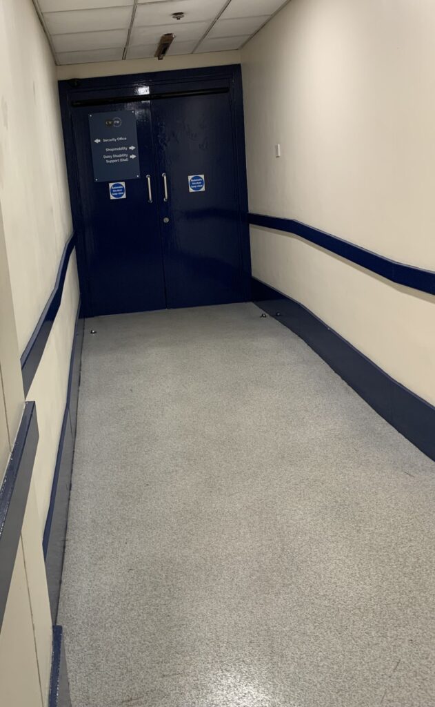 Corridor on Level 6 of Crowngate Car Park showing the route from the main lift to the blue double doors leading to ShopMobility Worcester.